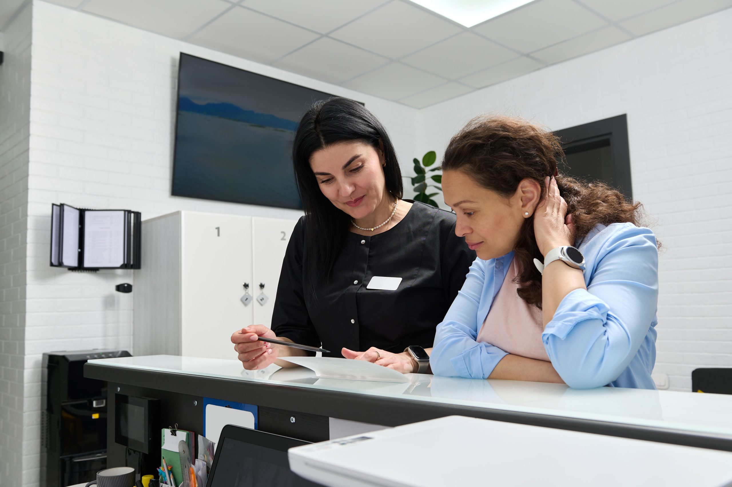 Front desk team member helping a new patient check in